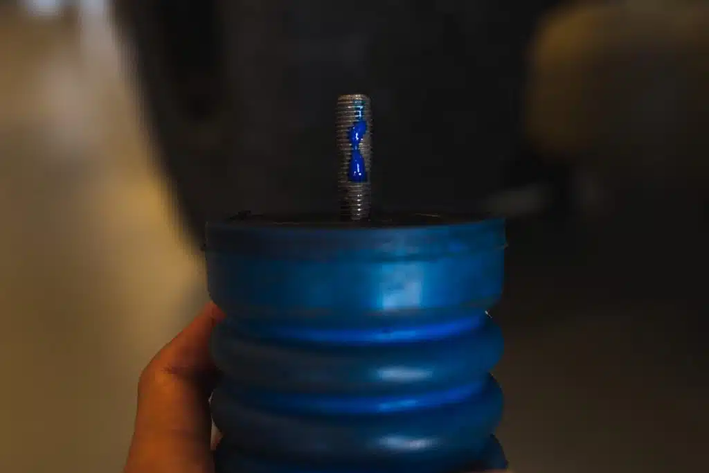 Applying a drop of Blue Thread Locker to the thread of the SumoSprings for installation