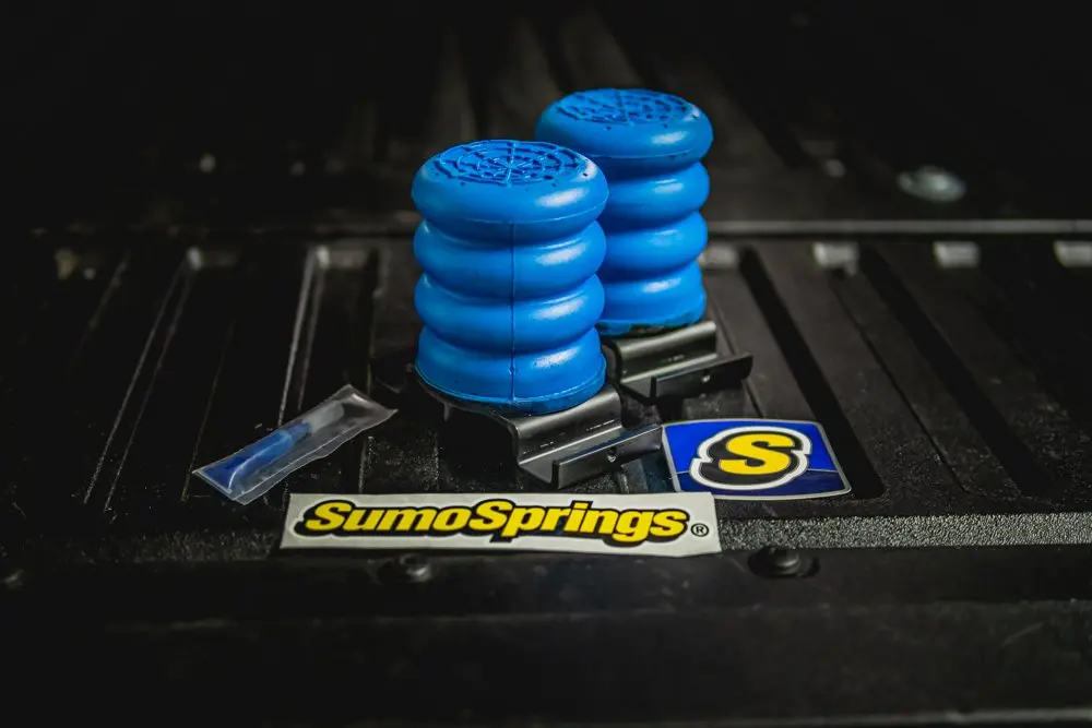 Blue SumoSprings sitting on the bed of a Toyota Tacoma