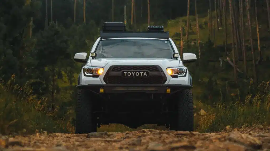 Toyota Tacoma driving on dirt road